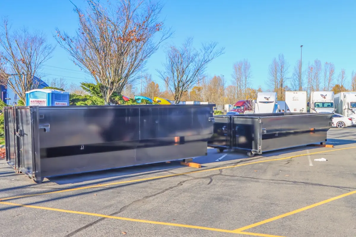 Professional dumpster rental service with roll-off container on residential driveway in Roscoe